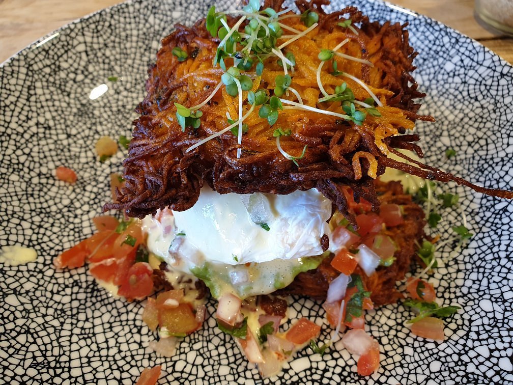 Crisp brunch rosti topped with greens and poached egg